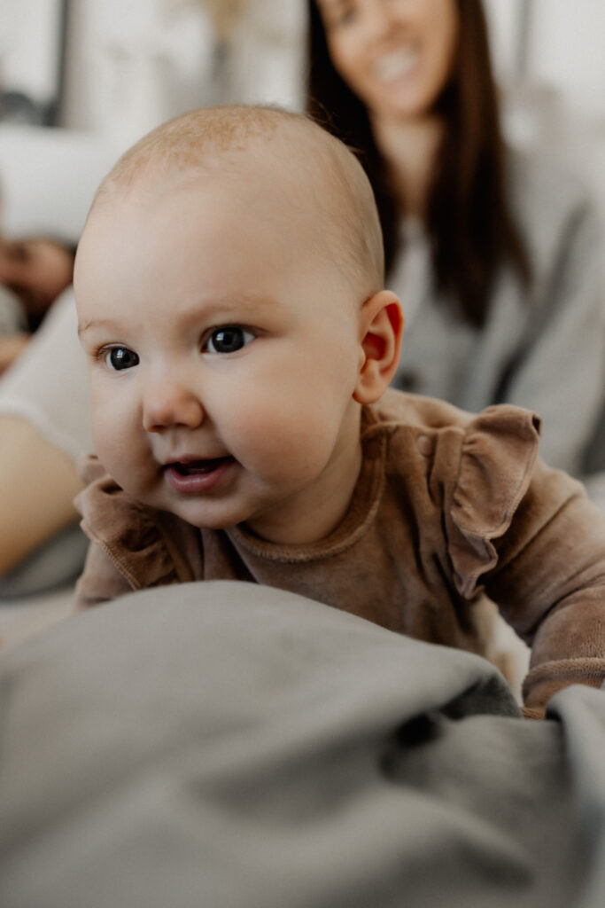 Familienshooting. Kleinkind robbt auf Kamera zu.